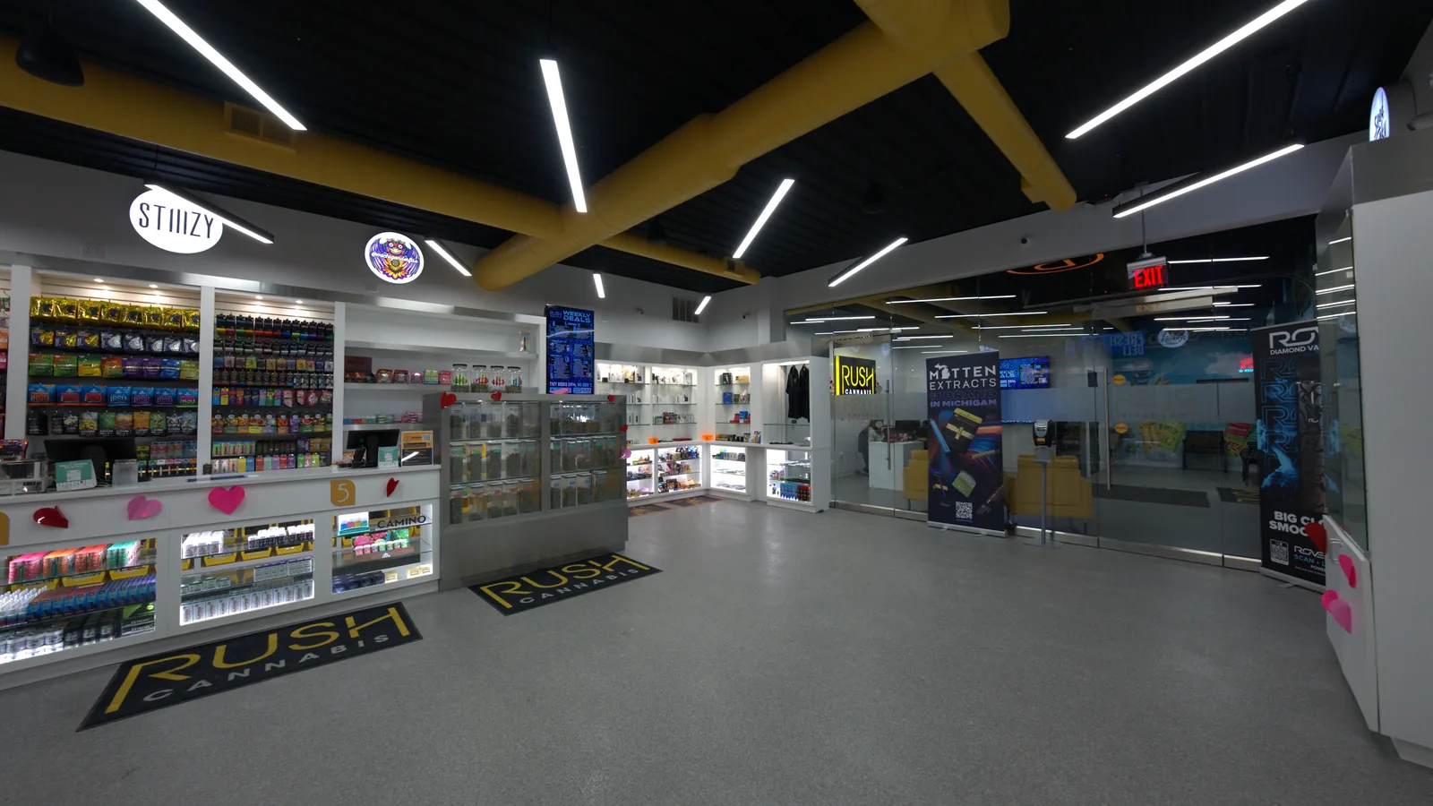 The RUSH Cannabis Oxford sales floor seen from the entrance, with branded floor mats
