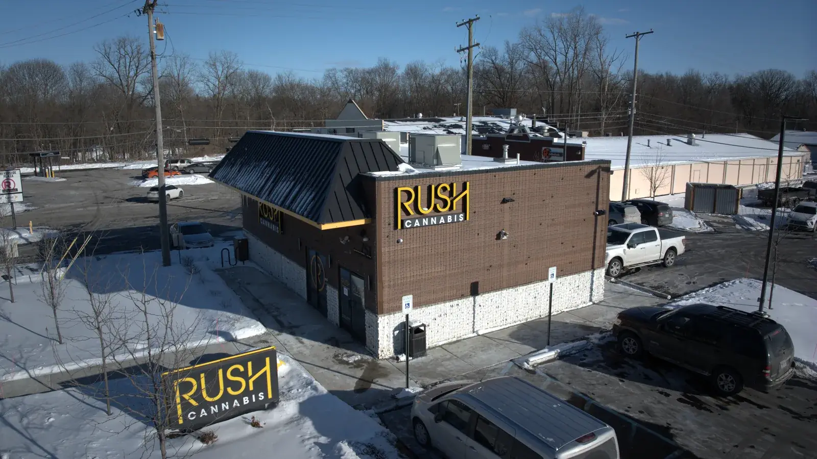Aerial view of the RUSH Cannabis Saline store and its gold signage
