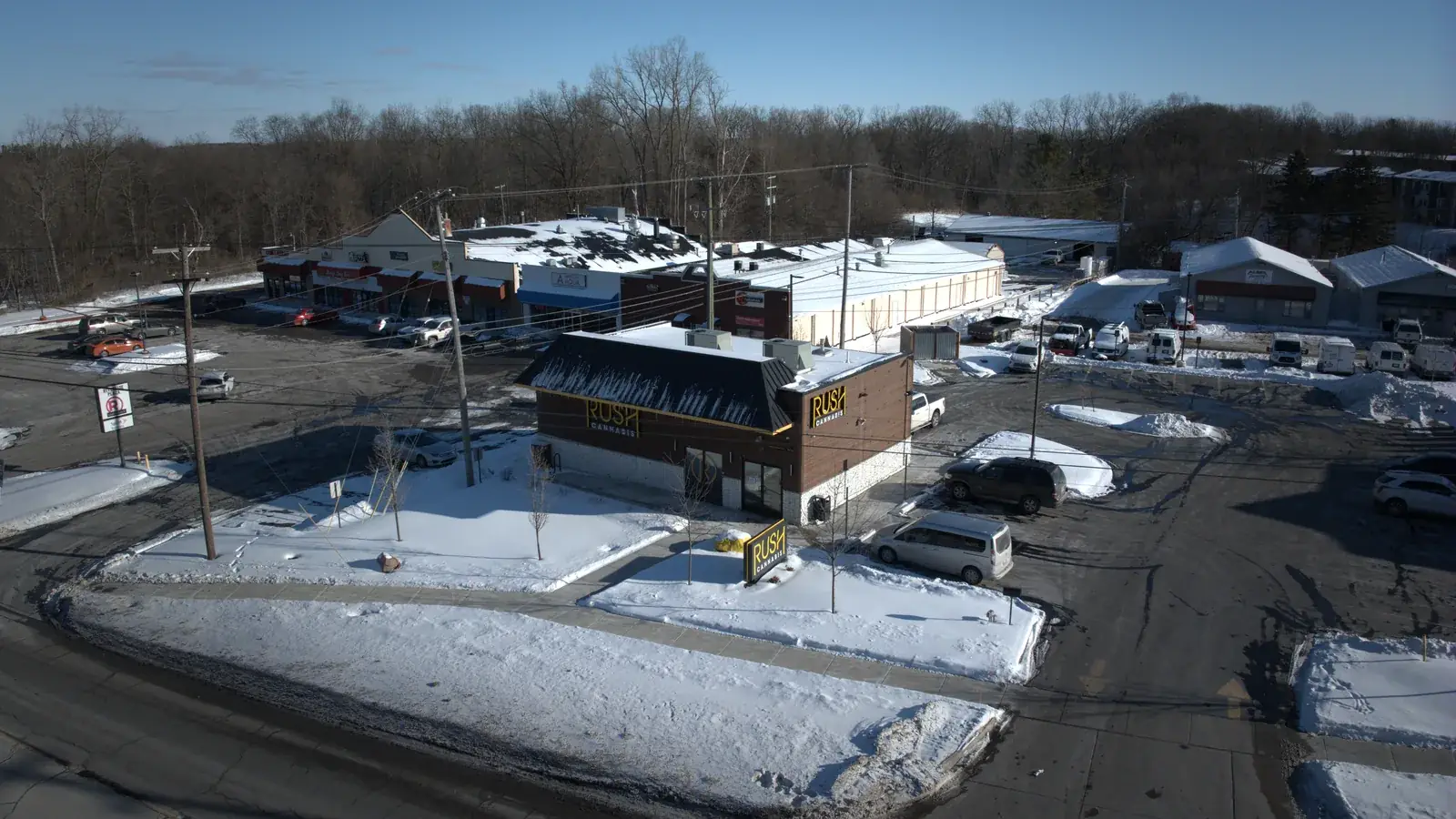 Wide aerial of RUSH Cannabis Saline on its corner lot in Riverside Plaza
